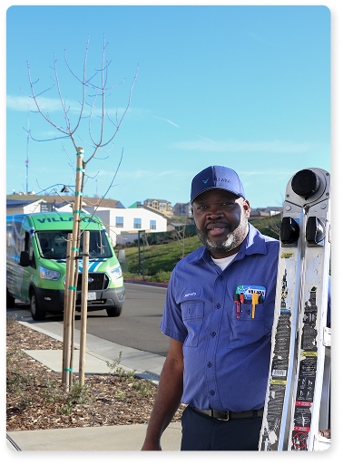 Technician carrying ladder