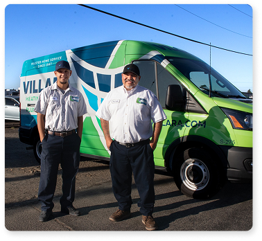 Technicians standing in front of van